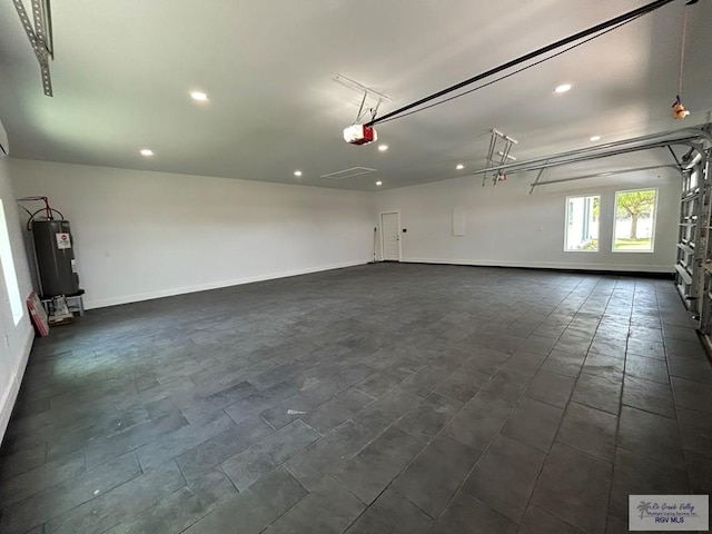 garage featuring a garage door opener and water heater