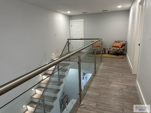 stairs with hardwood / wood-style flooring