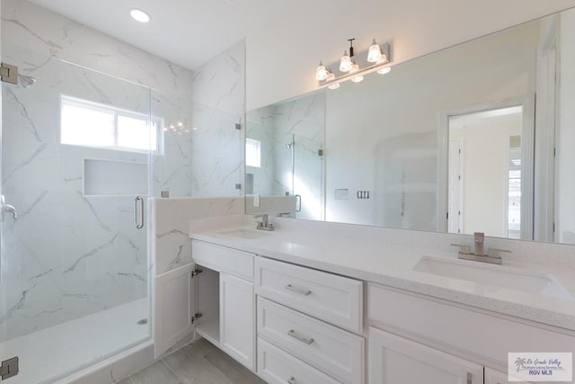 bathroom with vanity and an enclosed shower