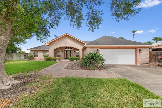 ranch-style house with a garage and a front yard