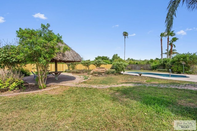 view of yard with a fenced in pool