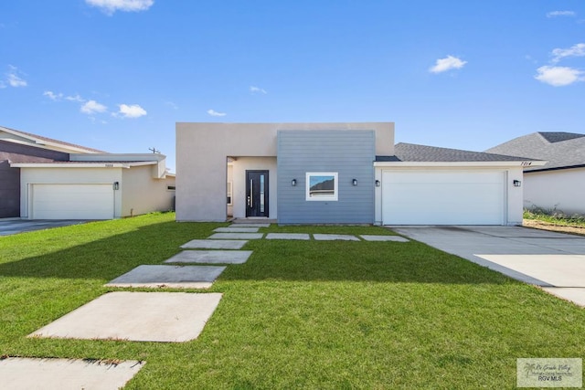 view of front of property with a front lawn and a garage