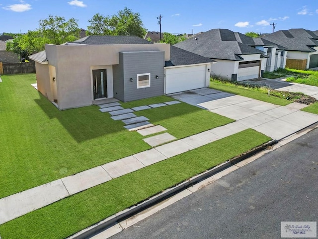 view of front of property featuring a front lawn and a garage