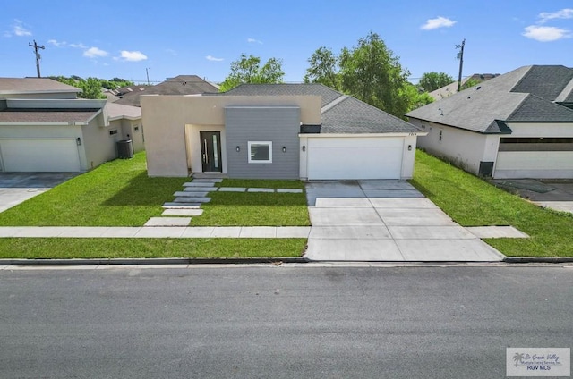 view of front of home with a front lawn and a garage