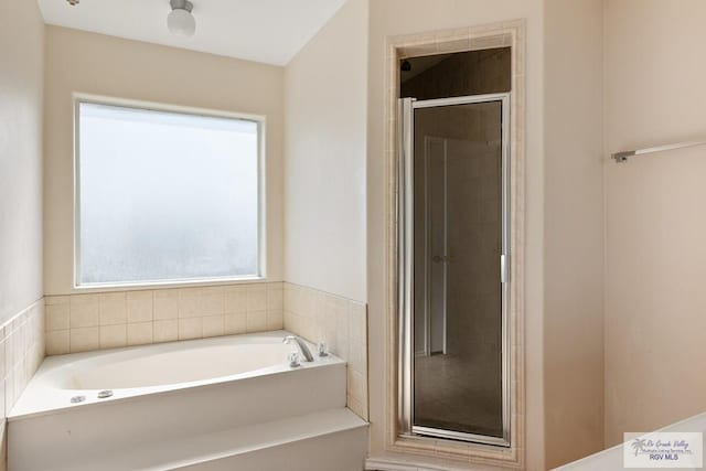 bathroom featuring separate shower and tub