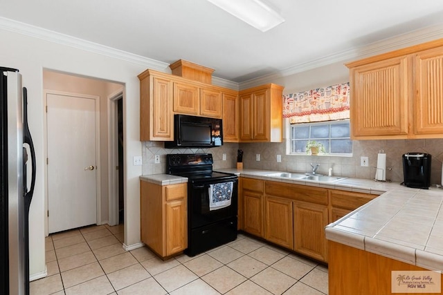 kitchen featuring sink, backsplash, crown molding, light tile patterned floors, and black appliances