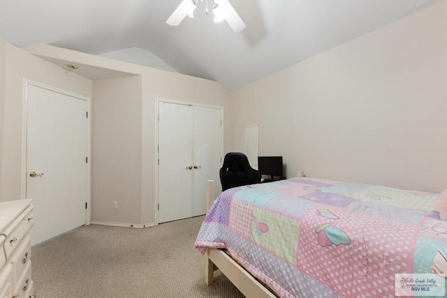 carpeted bedroom with ceiling fan, lofted ceiling, and a closet