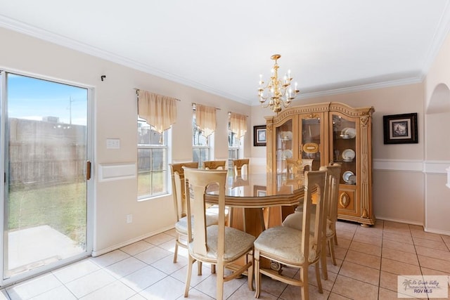 dining area with light tile patterned floors, a chandelier, and ornamental molding