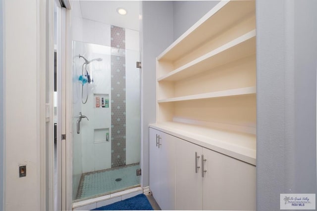 bathroom featuring tile patterned flooring and a shower with door