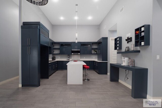 kitchen with a kitchen bar, a center island, and light hardwood / wood-style floors