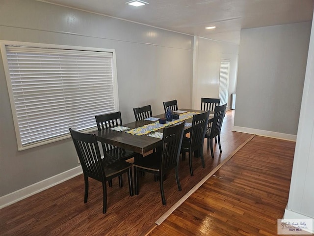 dining space with dark hardwood / wood-style flooring