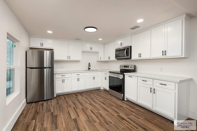 kitchen featuring sink, white cabinetry, and stainless steel appliances