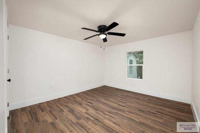 spare room with dark hardwood / wood-style floors and ceiling fan