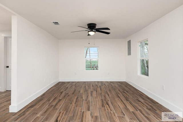 spare room featuring electric panel, dark hardwood / wood-style floors, and ceiling fan