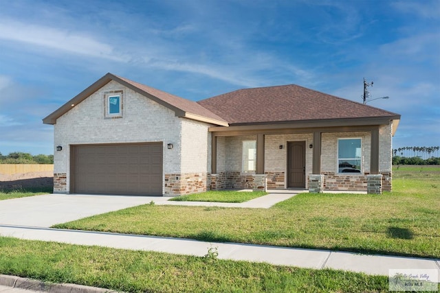 view of front of house with a garage, covered porch, and a front lawn