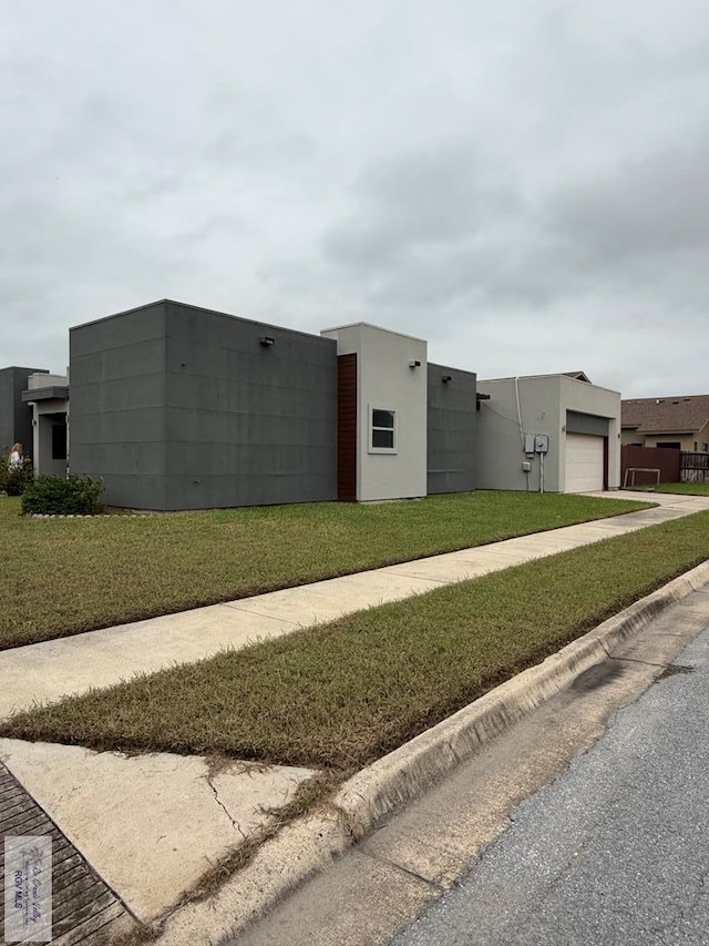 view of side of home featuring a yard and a garage