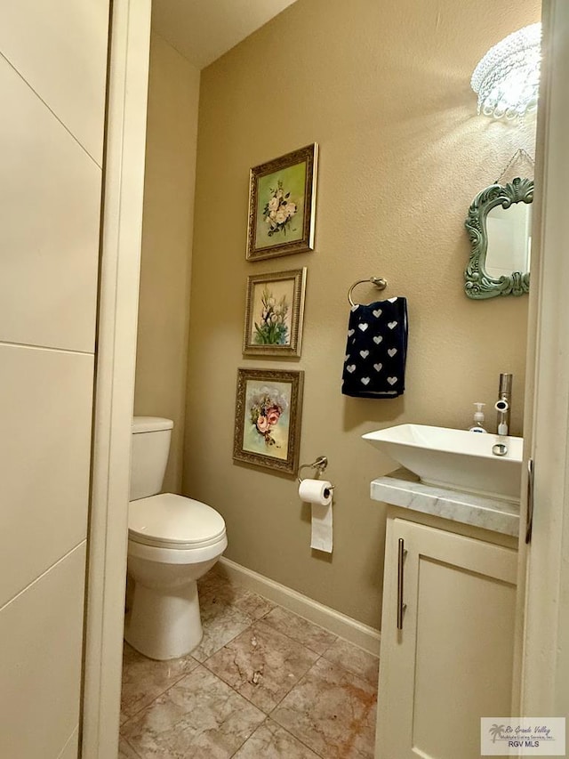 bathroom with tile patterned floors, vanity, and toilet