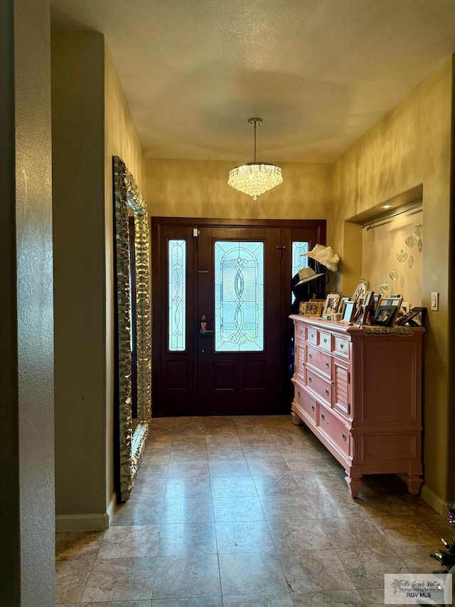 foyer featuring a chandelier