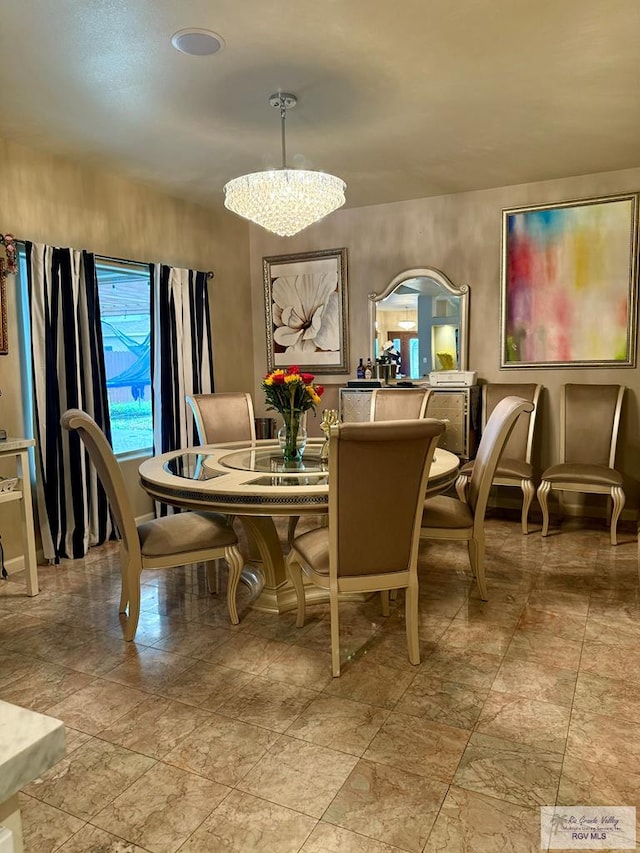 dining area featuring a notable chandelier