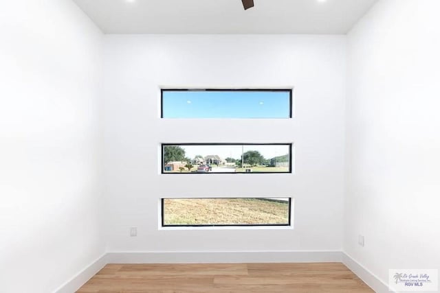 empty room with recessed lighting, baseboards, and light wood finished floors