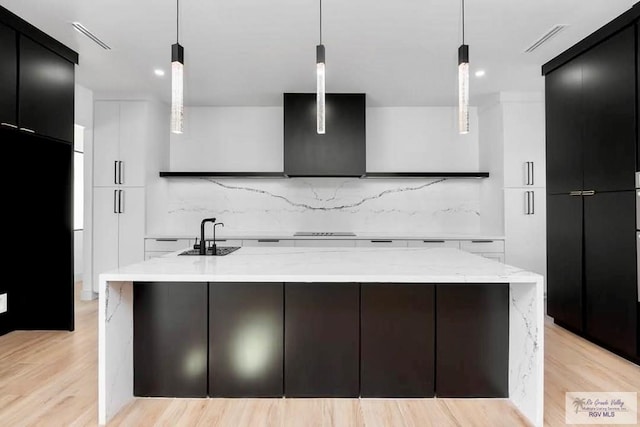 kitchen featuring modern cabinets, a sink, and decorative backsplash