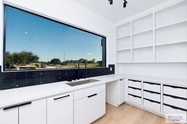 interior space featuring a sink and light wood-style floors