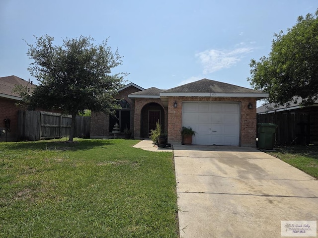 645 Windwood Way, Brownsville, TX 78526 - view of front of property featuring a garage, driveway, and brick siding