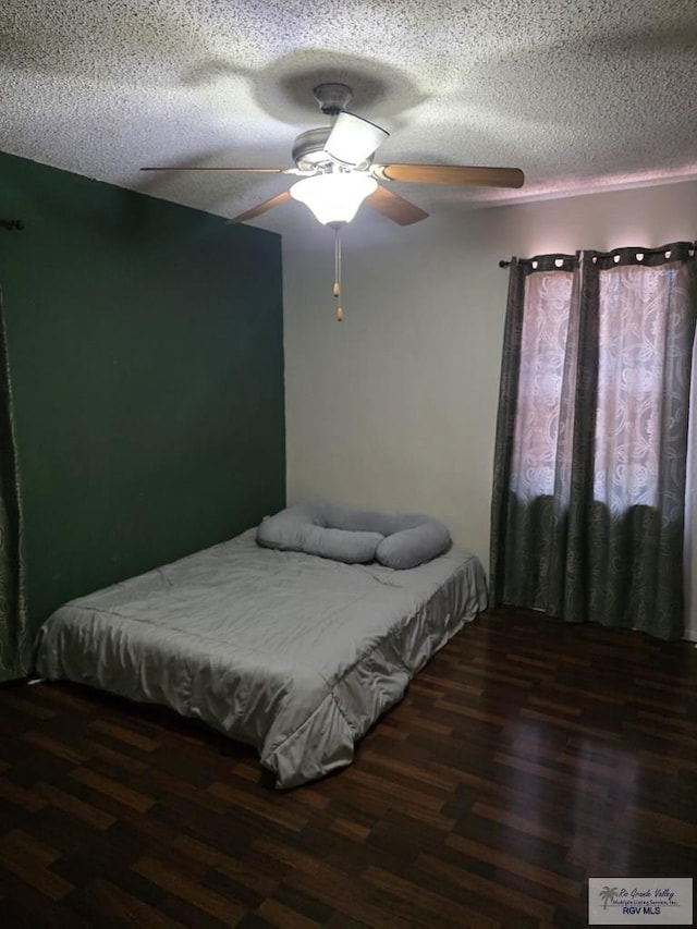 645 Windwood Way, Brownsville, TX 78526 - bedroom with wood finished floors, a textured ceiling, and a ceiling fan