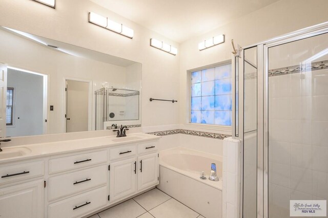 212 E Xenops Ave, Mcallen, TX 78504 - bathroom featuring a stall shower, a bath, double vanity, and tile patterned floors