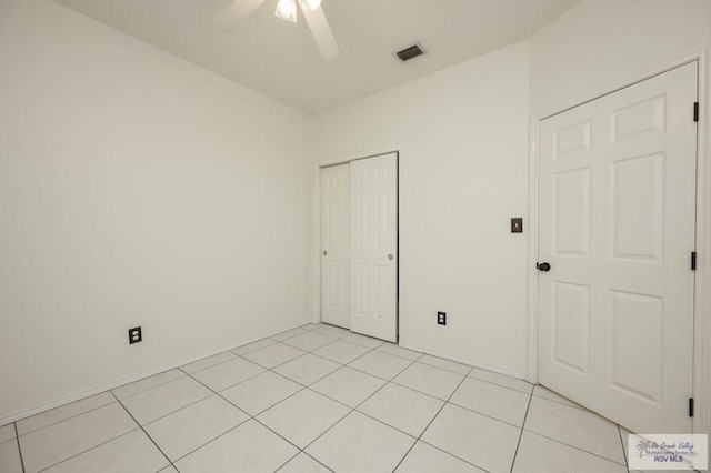 212 E Xenops Ave, Mcallen, TX 78504 - unfurnished bedroom featuring a closet, light tile patterned flooring, and ceiling fan
