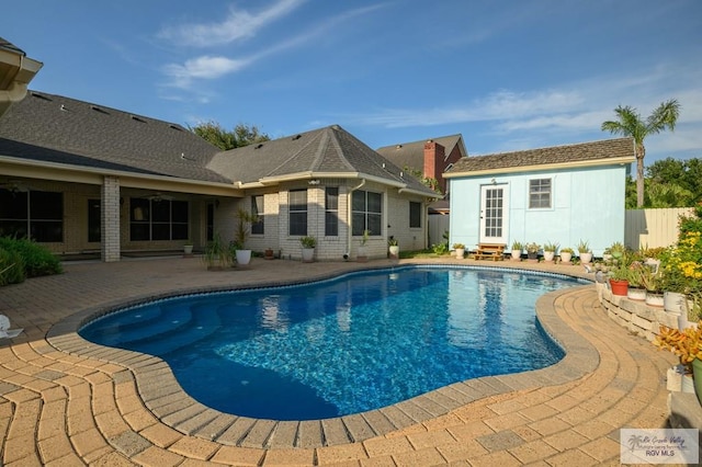 212 E Xenops Ave, Mcallen, TX 78504 - view of swimming pool featuring a patio area and an outbuilding