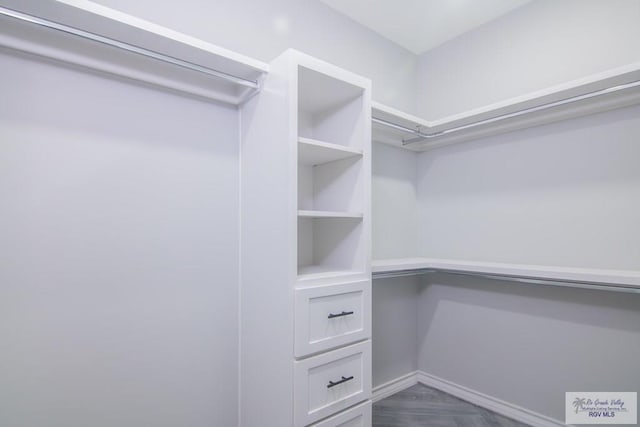 walk in closet featuring dark parquet floors