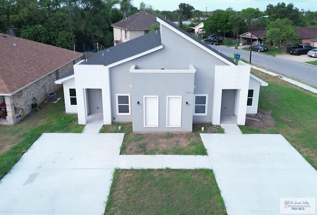 contemporary house featuring cooling unit and a front yard