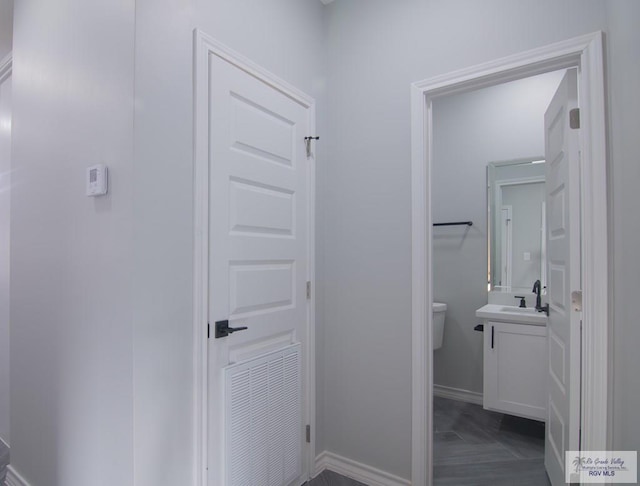 bathroom featuring vanity and toilet