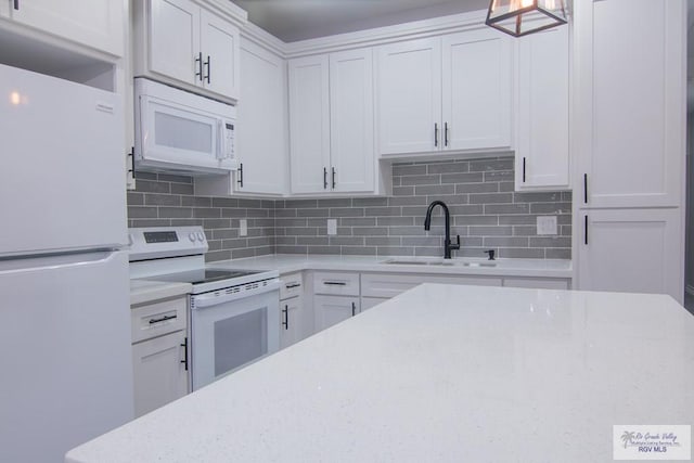 kitchen featuring white cabinets, white appliances, backsplash, and sink