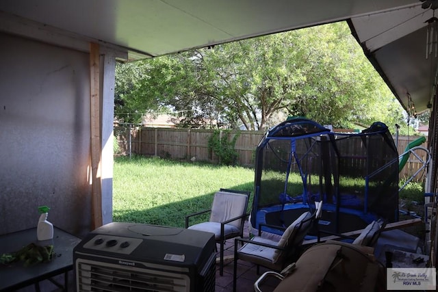 view of patio with a trampoline and area for grilling