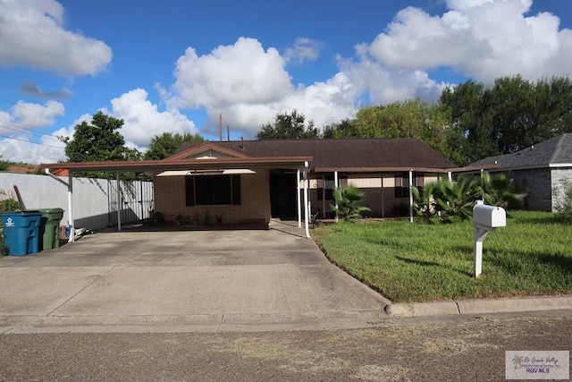view of front of home with a front yard and a carport