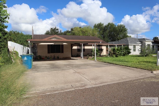 single story home featuring a front lawn and a carport