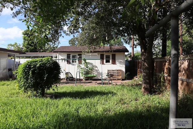 rear view of house with a yard