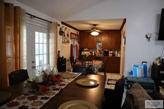 tiled dining room with vaulted ceiling and ceiling fan