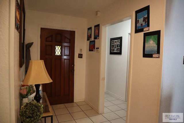 foyer entrance with light tile patterned floors