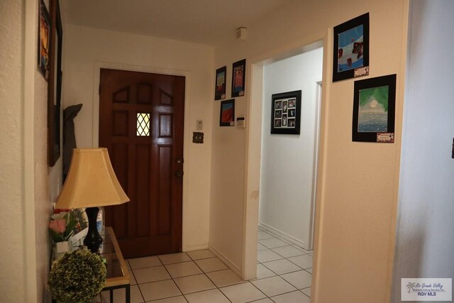 foyer entrance with light tile patterned floors