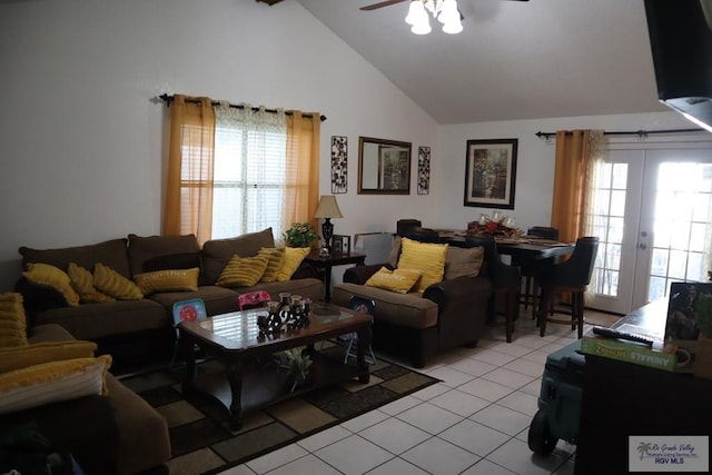 living room featuring ceiling fan, french doors, light tile patterned floors, and vaulted ceiling