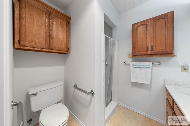 bathroom featuring a shower with shower curtain, vanity, toilet, and tile patterned flooring