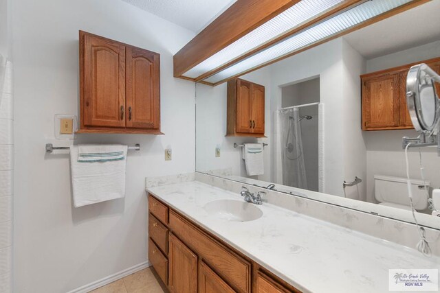 bathroom featuring tile patterned floors, a shower with curtain, toilet, and vanity