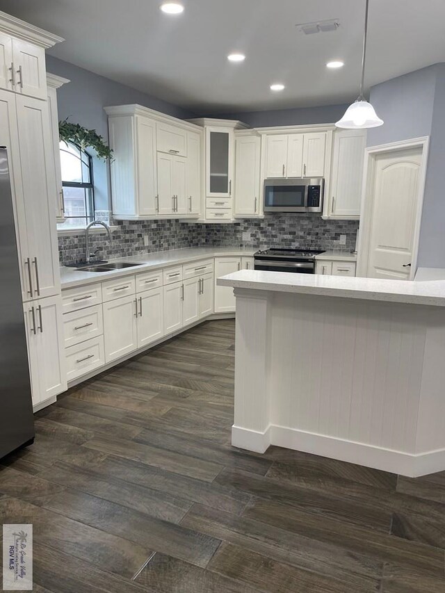 kitchen featuring white cabinets and dark hardwood / wood-style flooring