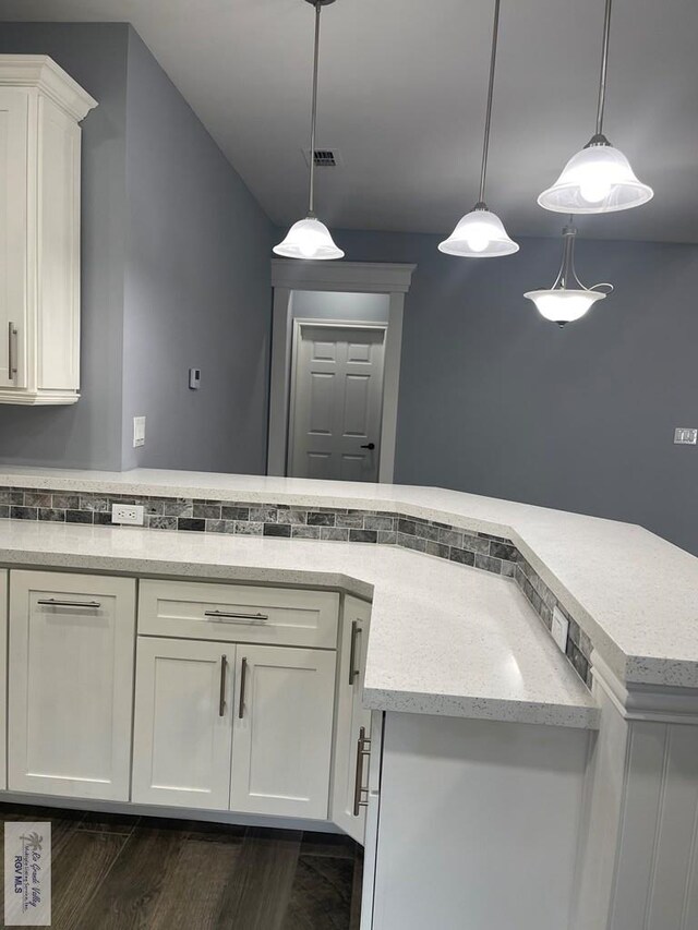 unfurnished bedroom with dark hardwood / wood-style floors, ceiling fan, a tray ceiling, and a closet