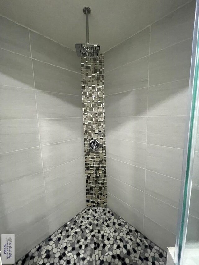 bathroom with tiled shower