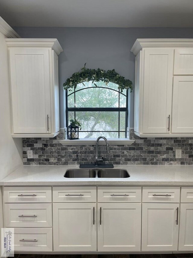 kitchen with decorative backsplash, dark hardwood / wood-style flooring, white cabinetry, and hanging light fixtures