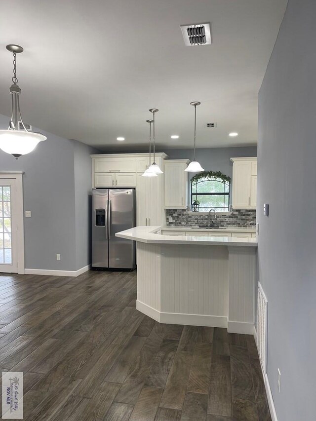 unfurnished bedroom with a closet, dark hardwood / wood-style floors, a raised ceiling, and ceiling fan